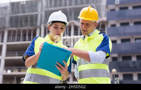 Two qualified engineers are discussing a construction plan Stock Photo