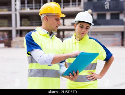 Two qualified engineers are discussing a construction plan Stock Photo