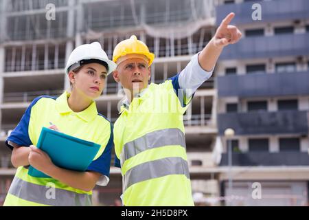 Two qualified engineers are discussing a construction plan Stock Photo