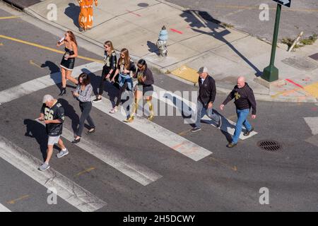 NEW ORLEANS, LA, USA - OCTOBER 31, 2021: Football fans on the crosswalk as they make their way to the stadium in downtown New Orleans Stock Photo