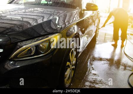 Outdoor car wash with foam soap. Stock Photo