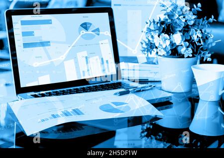 laptop with financial charts and graphs. Business concept double exposure Stock Photo