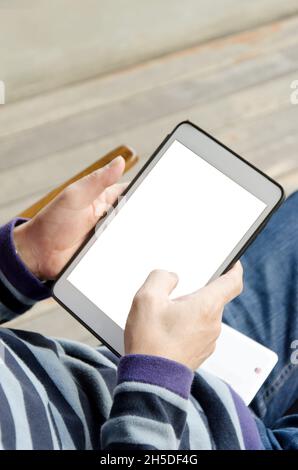 Close up hands multitasking man using tablet Stock Photo