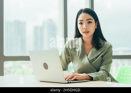 Businesswoman using laptop computer on work spec , Women trader online trading Stock Photo