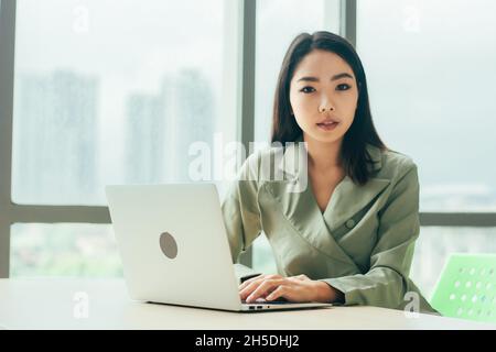 Businesswoman using laptop computer on work spec , Women trader online trading Stock Photo