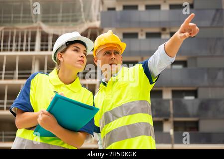 Two qualified engineers are discussing a construction plan Stock Photo