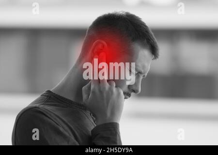 Man with strong earache or ear pain. Otitis Stock Photo