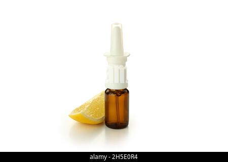 Blank bottle of nasal spray and lemon slice isolated on white background Stock Photo