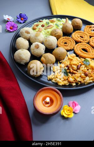 Indian festival food - Diwali Special sweet and salty snacks such as, Chakli, rava laddu, besan ladu, poha chivda, and corn mixture, Namkeen snacks. Stock Photo