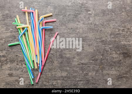 Drinking straws for party on Colored background. Top view of colorful plastic disposable straws for summer cocktails. different straws for juice with Stock Photo
