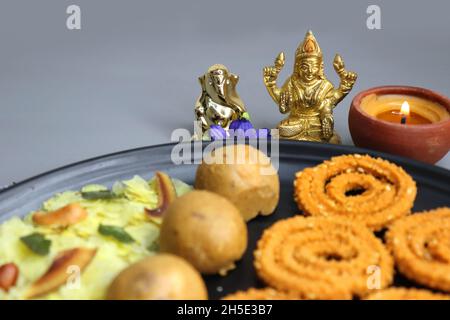 Indian festival food - Diwali Special sweet and salty snacks such as, Chakli, rava laddu, besan ladu, poha chivda, and corn mixture, Namkeen snacks. Stock Photo