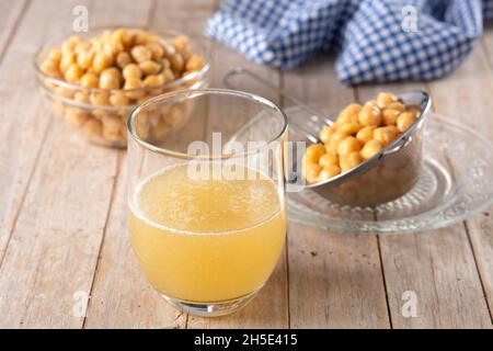 Chickpea water aquafaba on wooden table. Chickpea water is a substitute for eggs in pastries Stock Photo