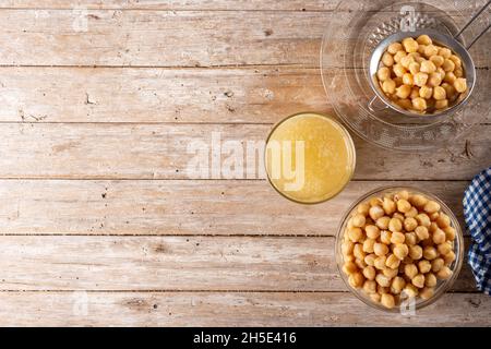 Chickpea water aquafaba on wooden table. Chickpea water is a substitute for eggs in pastries Stock Photo