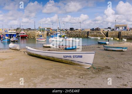 Traditional Cornish pilot gigs Sophia Storm and Concord beached on the beach in the historic picturesque working Newquay Harbour in Newquay in Cornwal Stock Photo