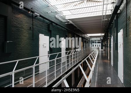 Alkmaar, The Netherlands-June 2021; Side view view into upper hallway with prison cells of former prison now renovated boutique The Fallon Hotel retai Stock Photo