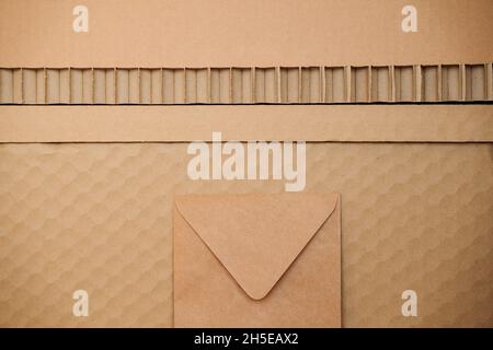 textured recycled cardboard background pattern with brown paper envelope Stock Photo