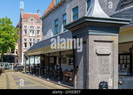 Alkmaar, The Netherlands-June 2021: View of a water pump in front of the former fish market of the city, now converted to a restaurant Stock Photo