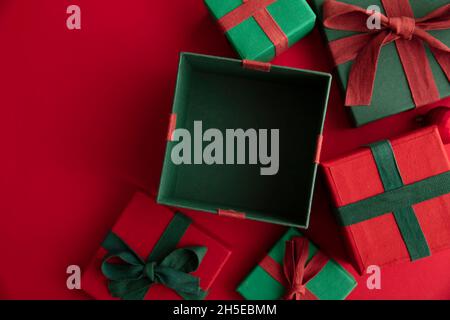 Open festive christmas present box on a red background. Flat lay, top view Stock Photo