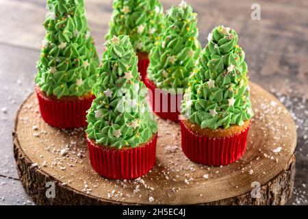 Christmas tree cupcakes on wooden table Stock Photo