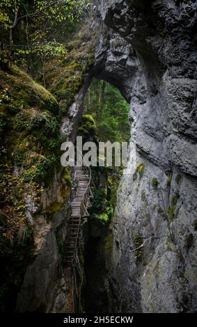 Devil's Path - picturesque eco-path and hiking trail in the Rhodopes mountains, Bulgaria. Wooden  bridge under the rock formation Devils bridge Stock Photo