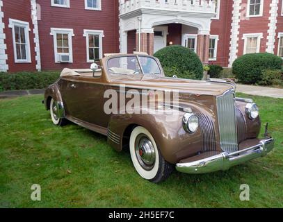 An antique 1941 Packard 160 convertible parked outside the Bayside Historical Society in Queens at a vintage car show. Stock Photo