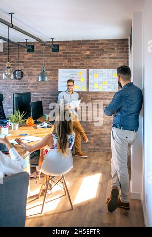 Coach giving a talk to workers in an office Stock Photo
