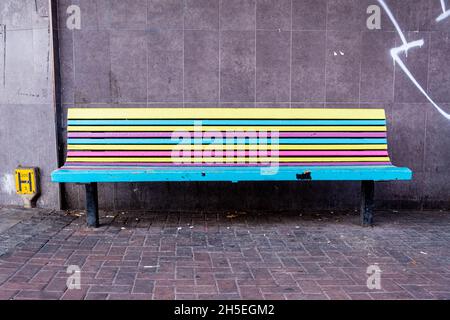 Kingston Upon Thames London England UK November 5 2021, Colourful Painted Wooden Park Bench In A Town Centre With No People Stock Photo