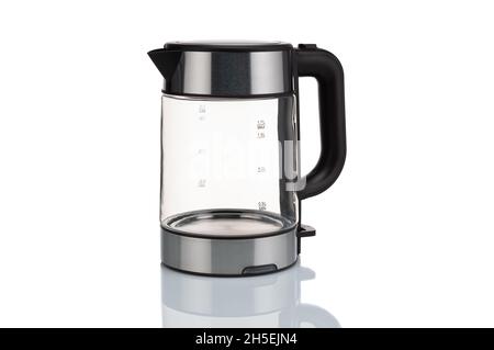 Glass, electric, modern transparent kettle on a white background. Close-up. Stock Photo