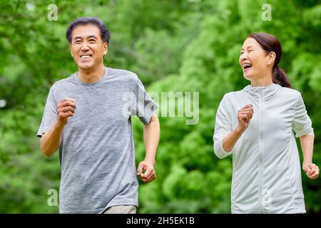 Japanese senior couple training at a city park Stock Photo - Alamy