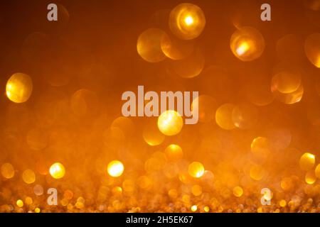 Orange bokeh background. Vintage glitter lights, glowing christmas effects backdrop Stock Photo
