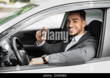 Handsome arabic businessman holding automatic car key Stock Photo