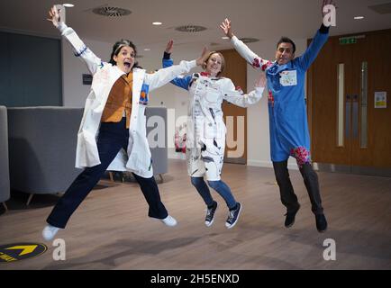 (left to right) Rosalind Wyatt, cancer patient Laura Nuttall and Professor Chris Jones wearing three lab coats which have been made into a 'wearable work of art', and are on display at the Institute of Cancer Research in Sutton, south west London. British textile artist Rosalind Wyatt has transformed three lab coats with hand-stitched quotes, letters and illustrations from children and adults with rare and hard to treat cancers, raising awareness of 'cancers of unmet need'. Picture date: Tuesday November 9, 2021. Stock Photo