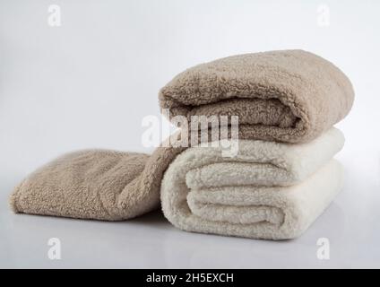 Soft and warm stack of folded blankets isolated on white background Stock Photo