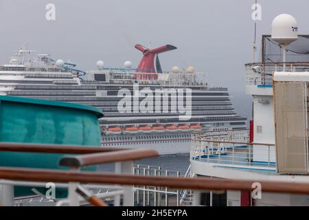 The Caribbean Sea - May 26, 2020: Shot of Carnival Horizon anchored at sea in the fog. Other Carnival cruise ship's open deck in the foreground. Grey Stock Photo