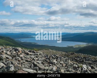 View over milky green Laitaure, Lajtavrre lake with rock, birch and spruce tree forest. Vast arctic landscape of Sarek National Park in Swedish Stock Photo