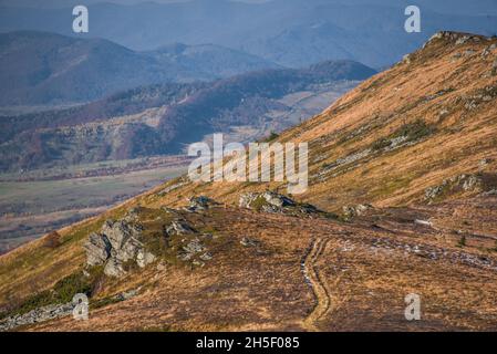 View of hills of Water Dividing ridge covered in red, orange and yellow ...