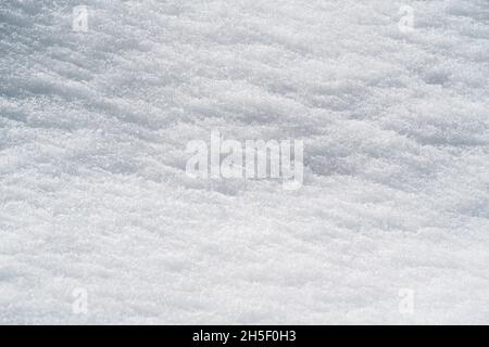 Winter background with close up of fine textured sunlit snow Stock Photo