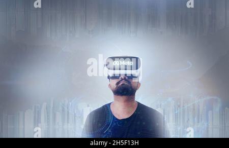 Guy Wearing Virtual Reality Goggles Inside A Metaverse - Meta Written On The Googles Stock Photo