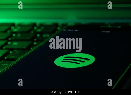 smartphone on a computer keyboard with the Spotify music app Stock Photo