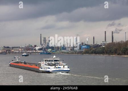 cargo vessel on the Rhine, view to the Chempark, former known as the Bayer factory, Leverkusen, North Rhine-Westphalia, Germany.   Frachtschiff auf de Stock Photo