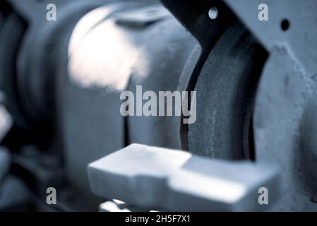 Round whetstone in a circular electric machine. Shallow depth of field. Stock Photo