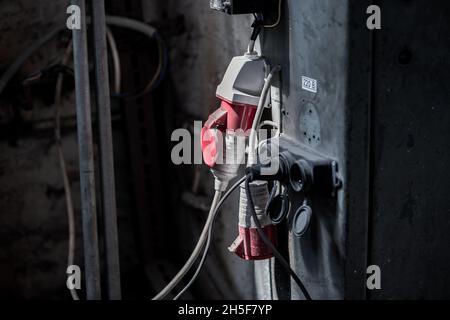 Wall mounted electrical outlets in an industrial room. Stock Photo