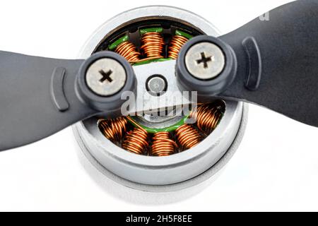 Macro photo of a drones brushless motor connected to plastic propellers, isolated on a white background. Stock Photo