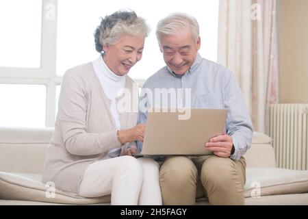 Happy elderly couples using a tablet computer Stock Photo