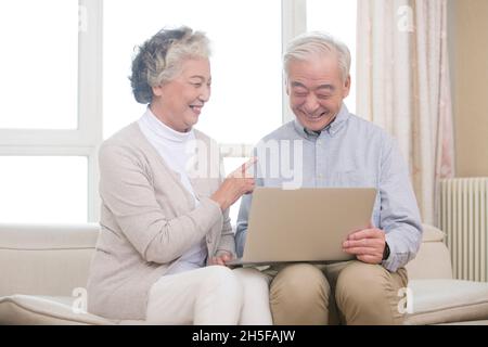 Happy elderly couples using a tablet computer Stock Photo