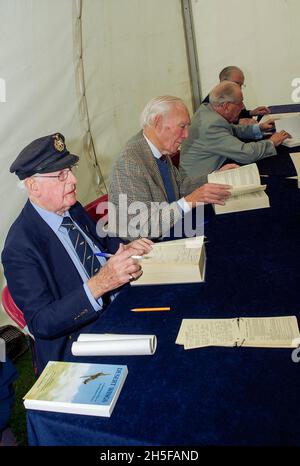 Veteran wartime RAF pilots at a book signing event. Elderly Royal Air Force wartime pilot signing books Stock Photo