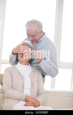 Old man giving his wife flowers Stock Photo