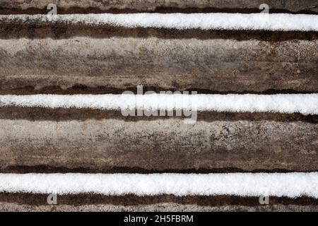 Slate background with snow lying on it. Stock Photo