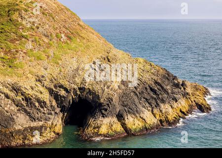 Cave in the sea cliffs at Roberts Cove, County Cork, Ireland Stock Photo