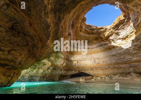 The seacave of Benagil is a well known tourist destination. The seacave has a hole in the roof and is accessed by boat. It is located in the Algarve r. Stock Photo